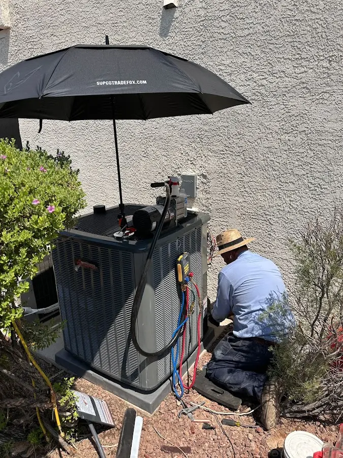 HVAC technician performing outdoor AC maintenance in Tobyhanna