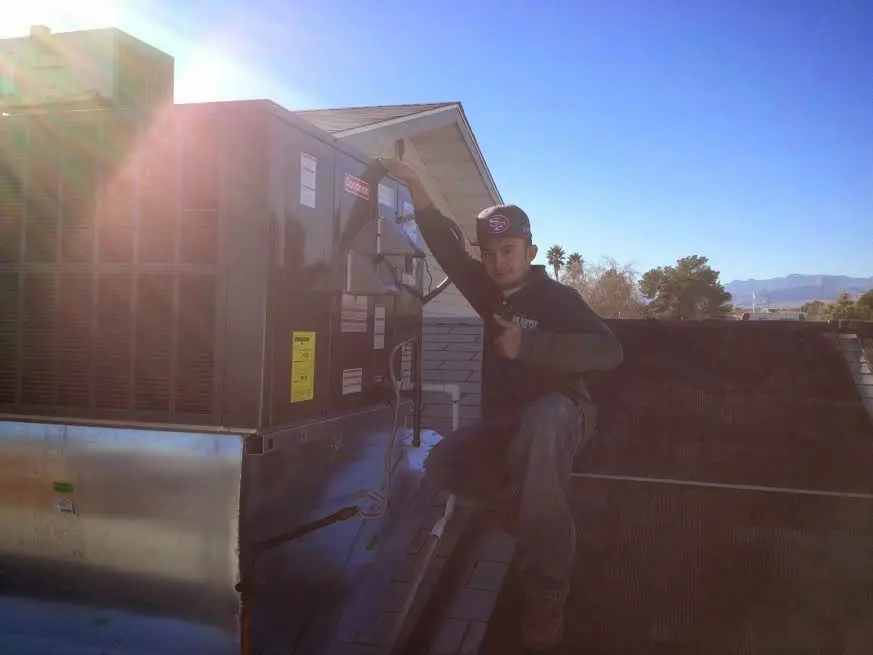 HVAC technician performing HVAC Inspection on a rooftop unit in Tobyhanna